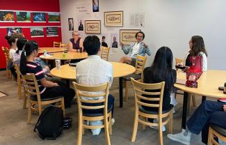 Students sit looking at Simon Donner in the front of the room speaking